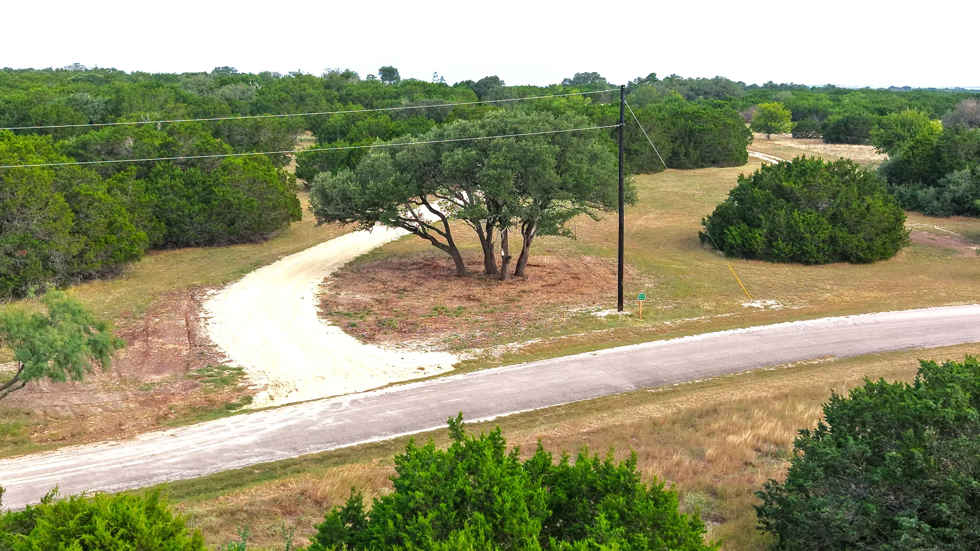 Gravel road winding through the rolling terrain at Legacy Oaks